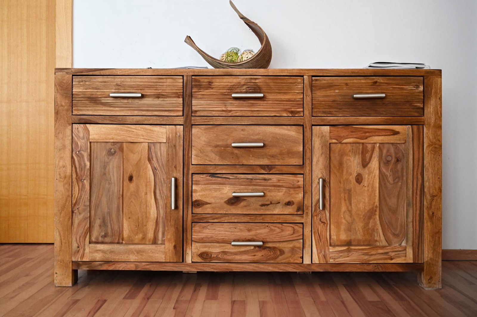 Close-up of cabinet doors and wood finish, which needs protecting from sun and damp