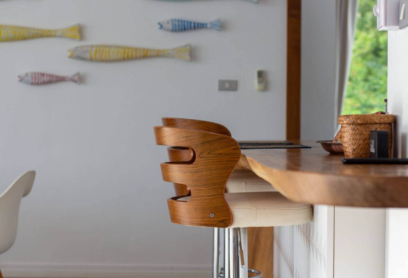 Taller stools at a raised bar counter, showing true bar height seating