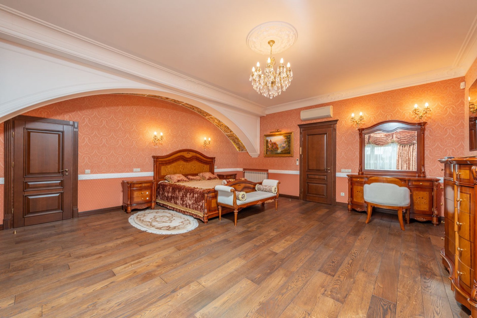 Upholstered bench at the foot of a bed, sitting just below mattress height