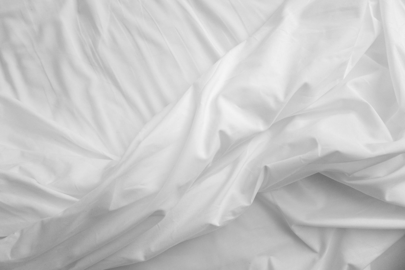 Folded bed sheets showing fabric texture and weave