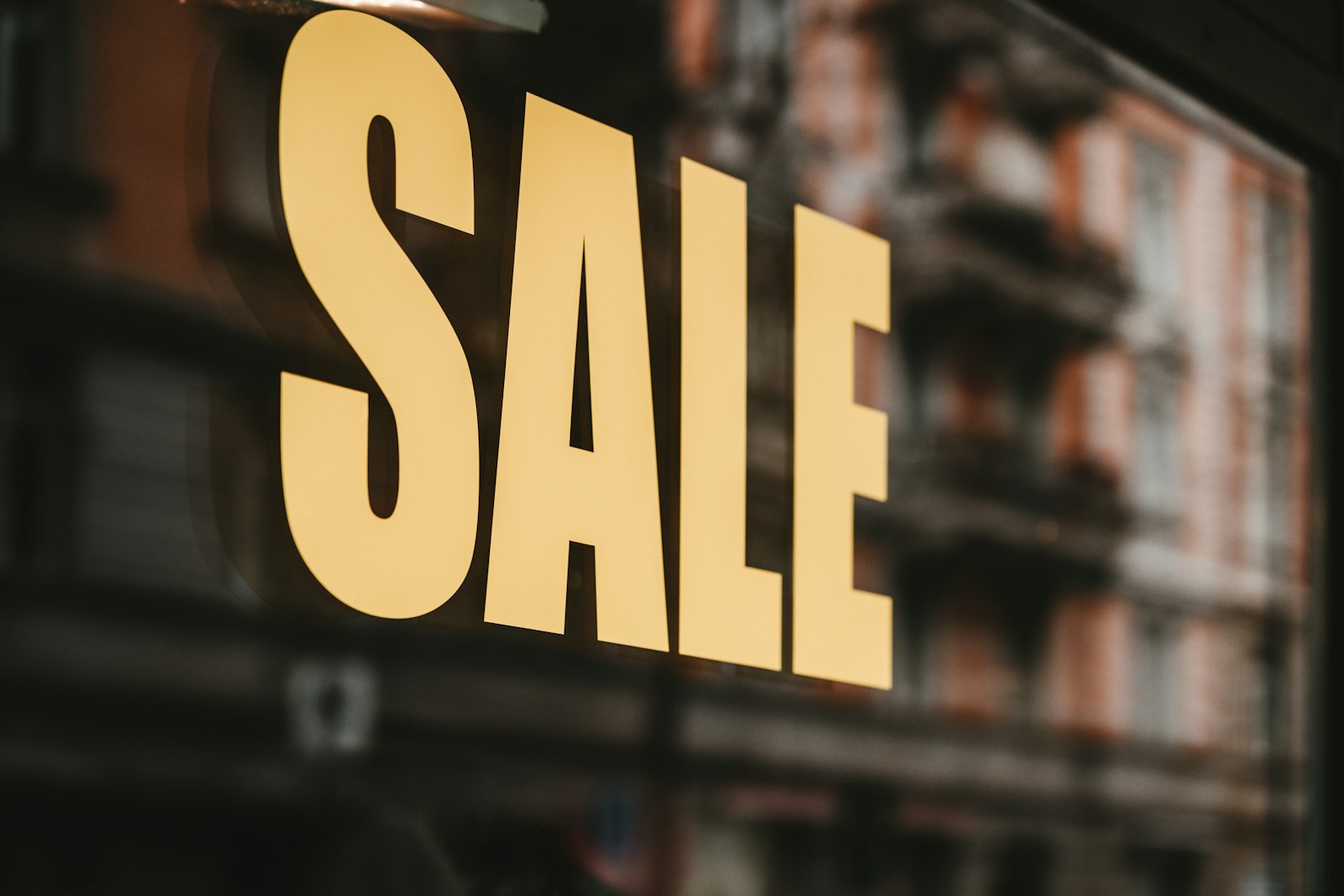 Yellow sale text printed on glass window