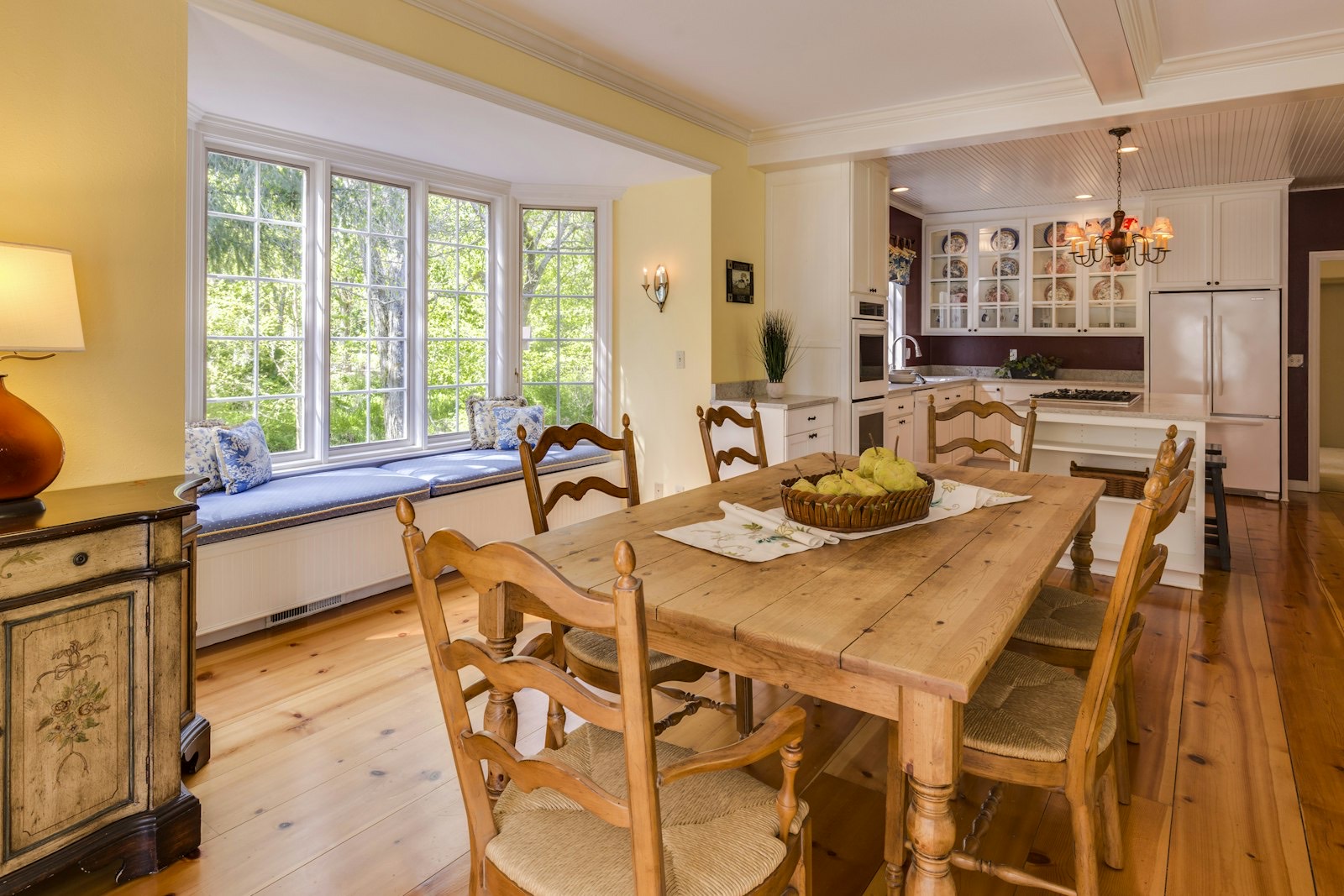 Wooden dining bench tucked under a table alongside chairs