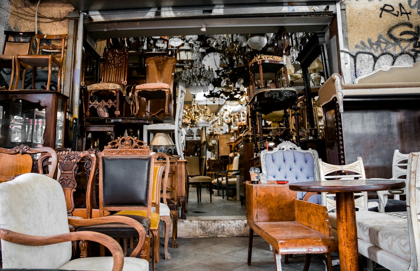Dining chairs displayed with tables in a showroom so legroom can be tested