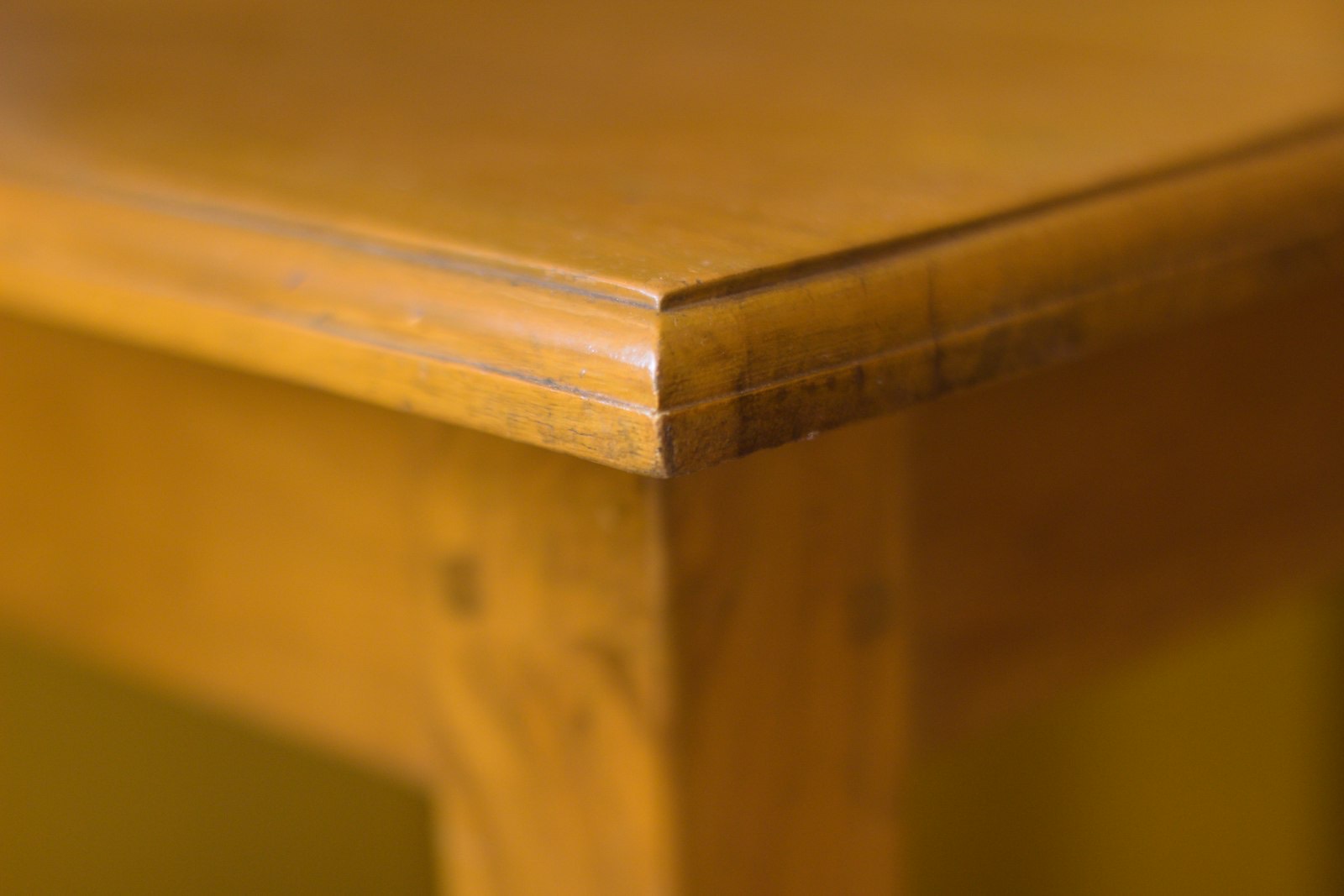Underside of a dining table showing the apron that limits bench clearance