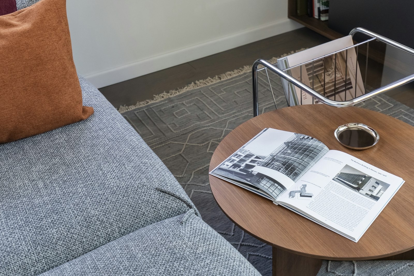 Upholstered chair in a living room corner, showing the compact footprint a glider needs