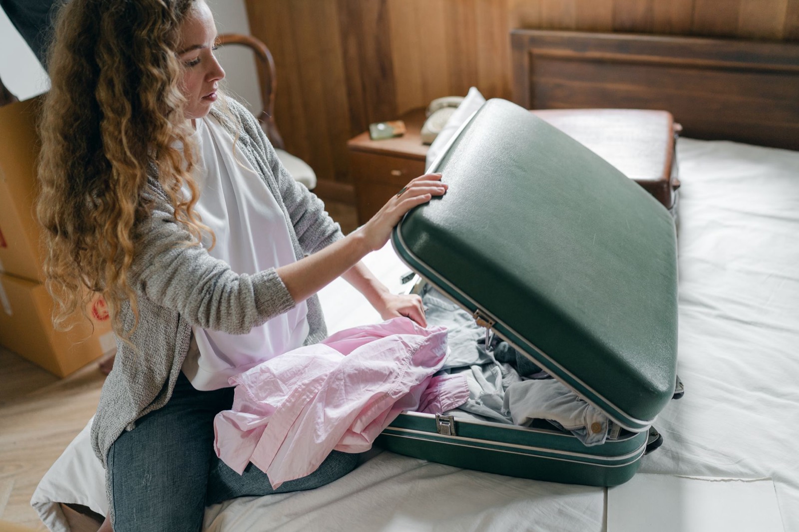 Suitcase on a bench at the foot of a guest bed instead of on the floor