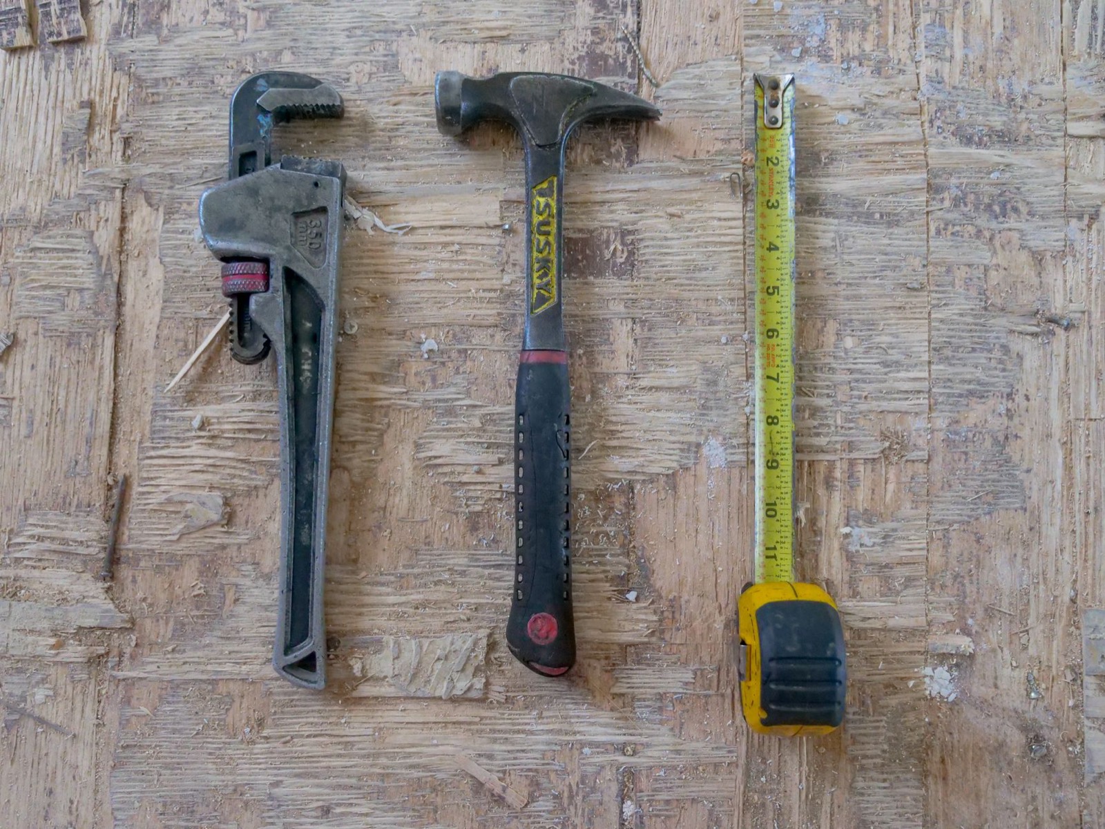 Measuring and marking a wall before driving fixings for a gallery arrangement