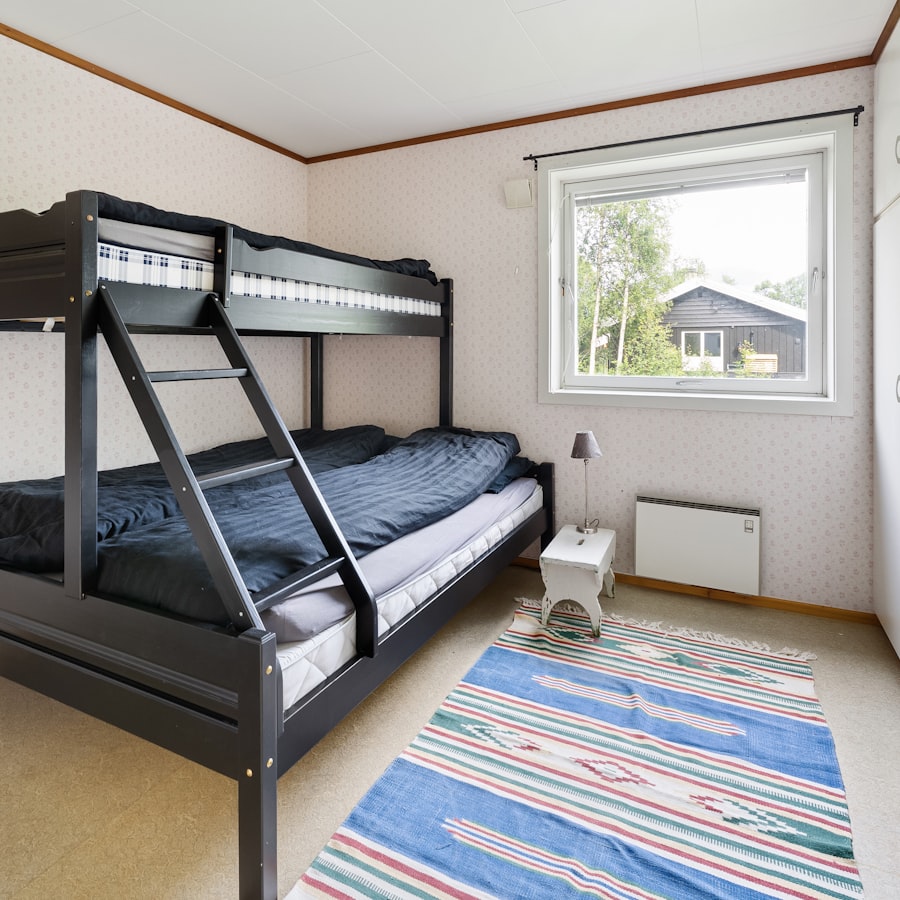 Black bunk bed with ladder in a bedroom