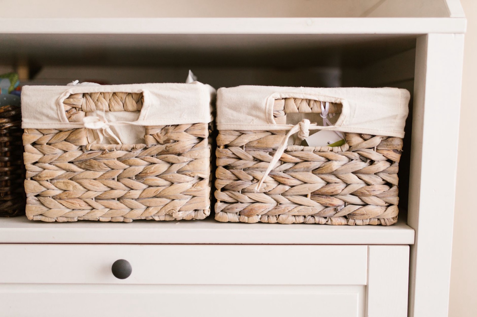 Open bins and cubbies that let a young child put things away unaided