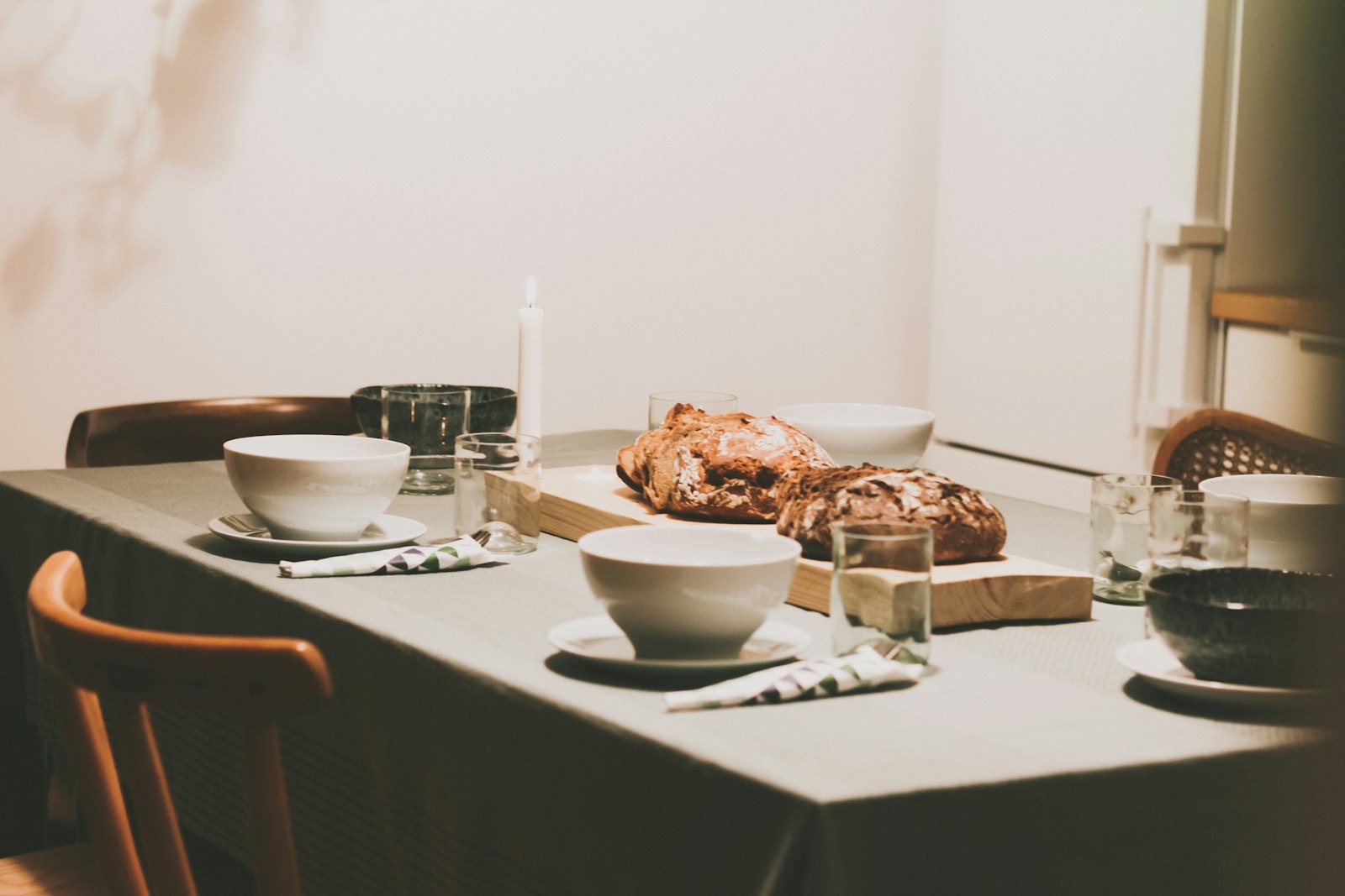 Long dining bench seating several people along one side of a table
