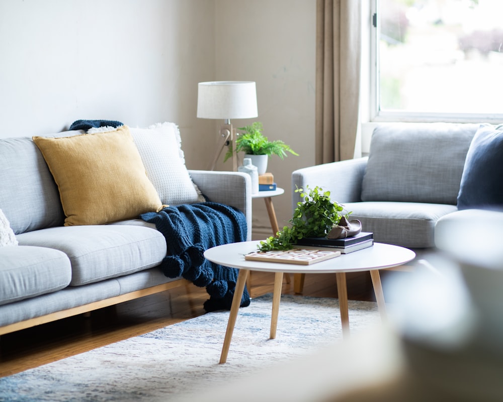 Cozy living room with gray sofas and round wood coffee table