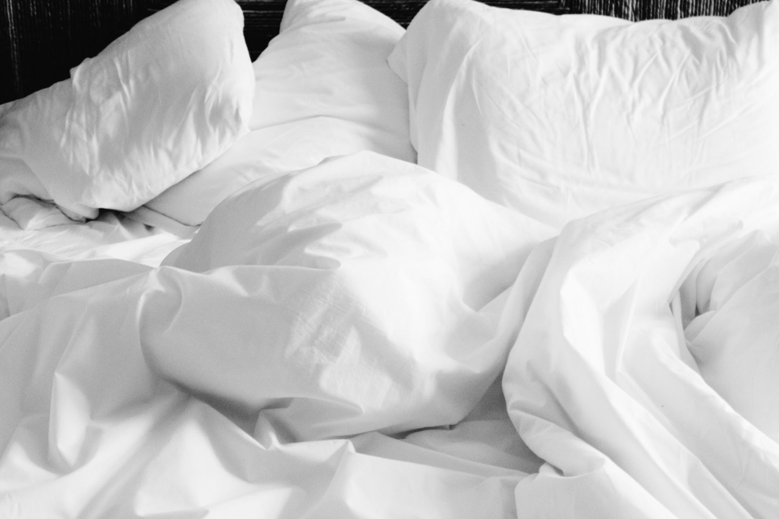 Fitted sheet stretched over a mattress corner, where added depth affects the fit