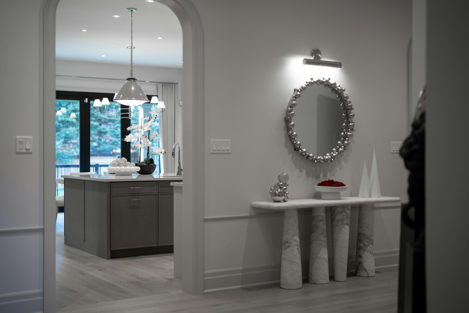 Mirror hung above a console table in an entryway at the correct proportion