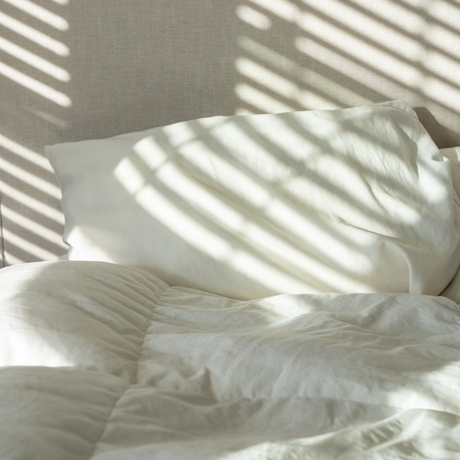 Sunlit bed with white linens