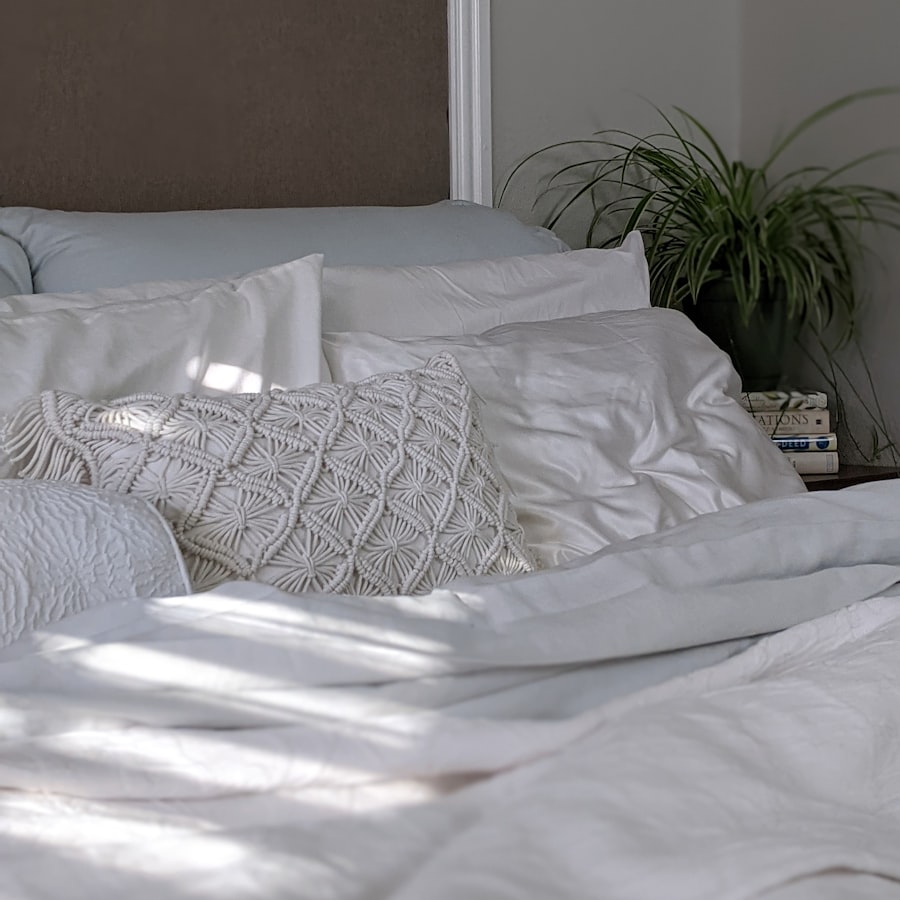 White bedroom with textured pillow and plant