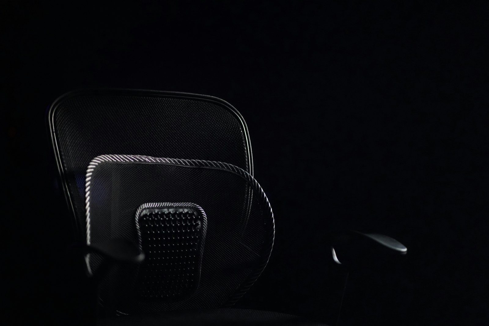 Office chair backrest showing the lumbar support that fills the lower back curve