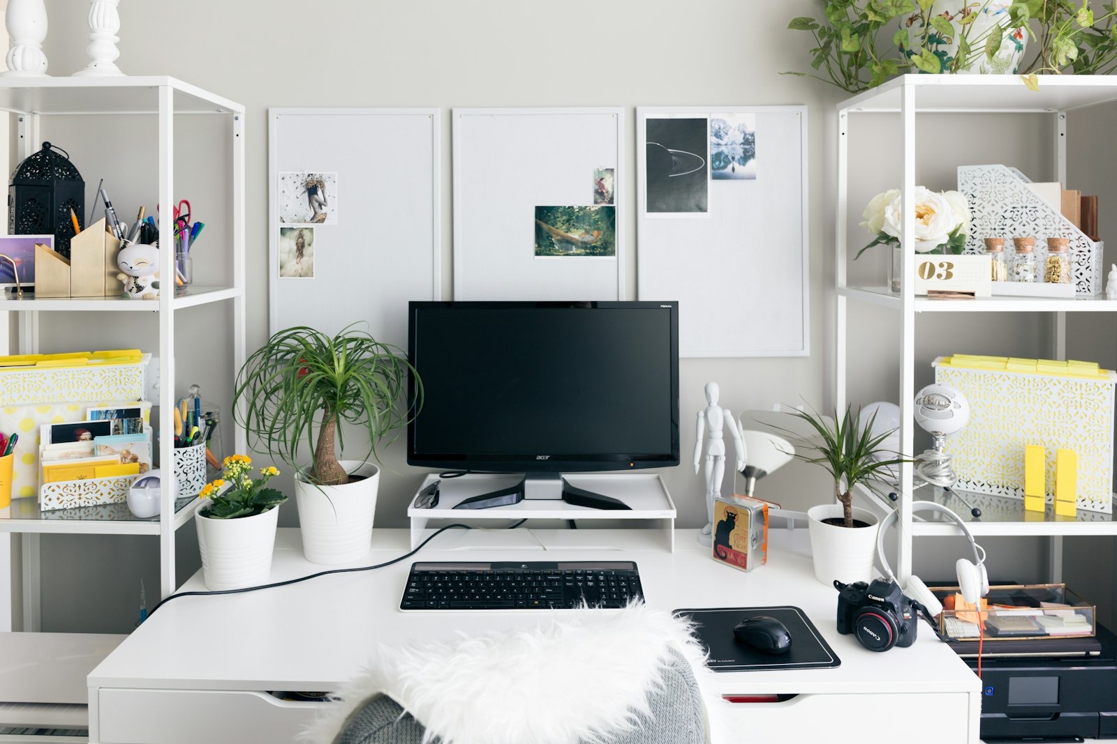 Home office workspace with a low storage cabinet running along the wall
