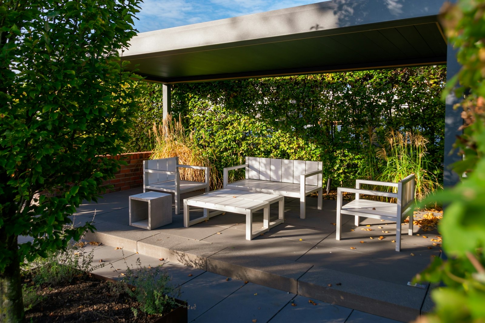 Outdoor seating arranged on a patio in summer sunlight
