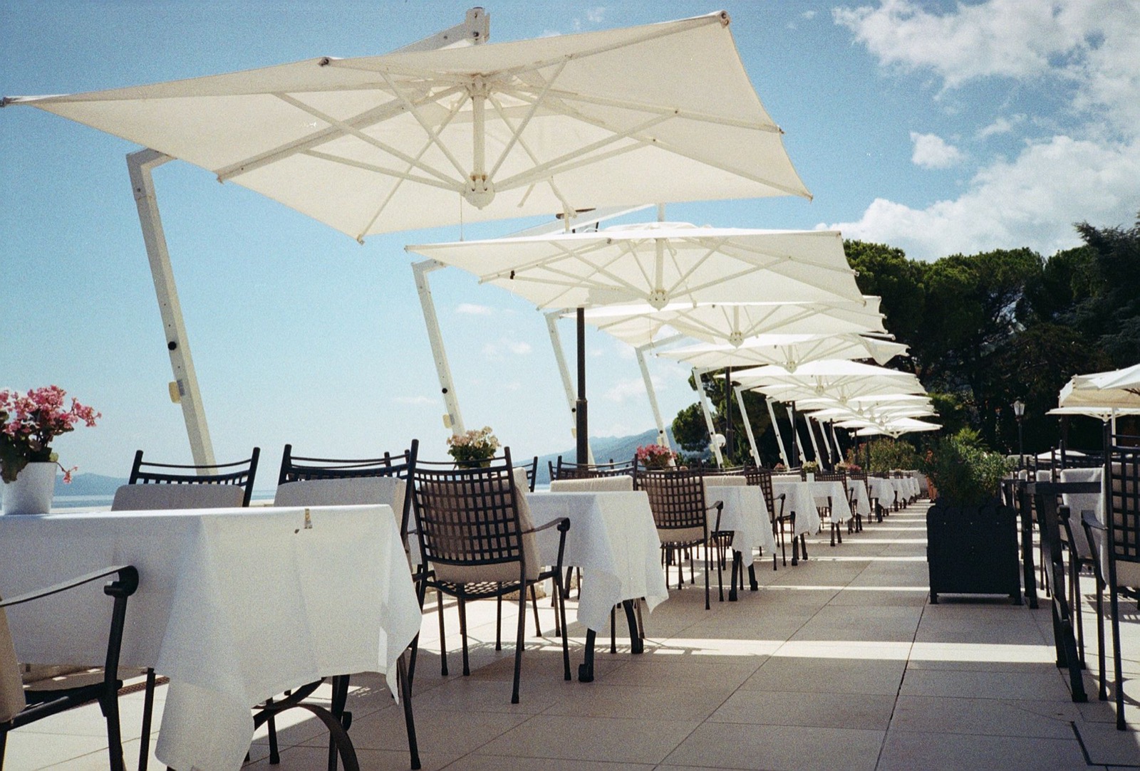 Patio umbrella providing shade that protects both furniture and people from UV