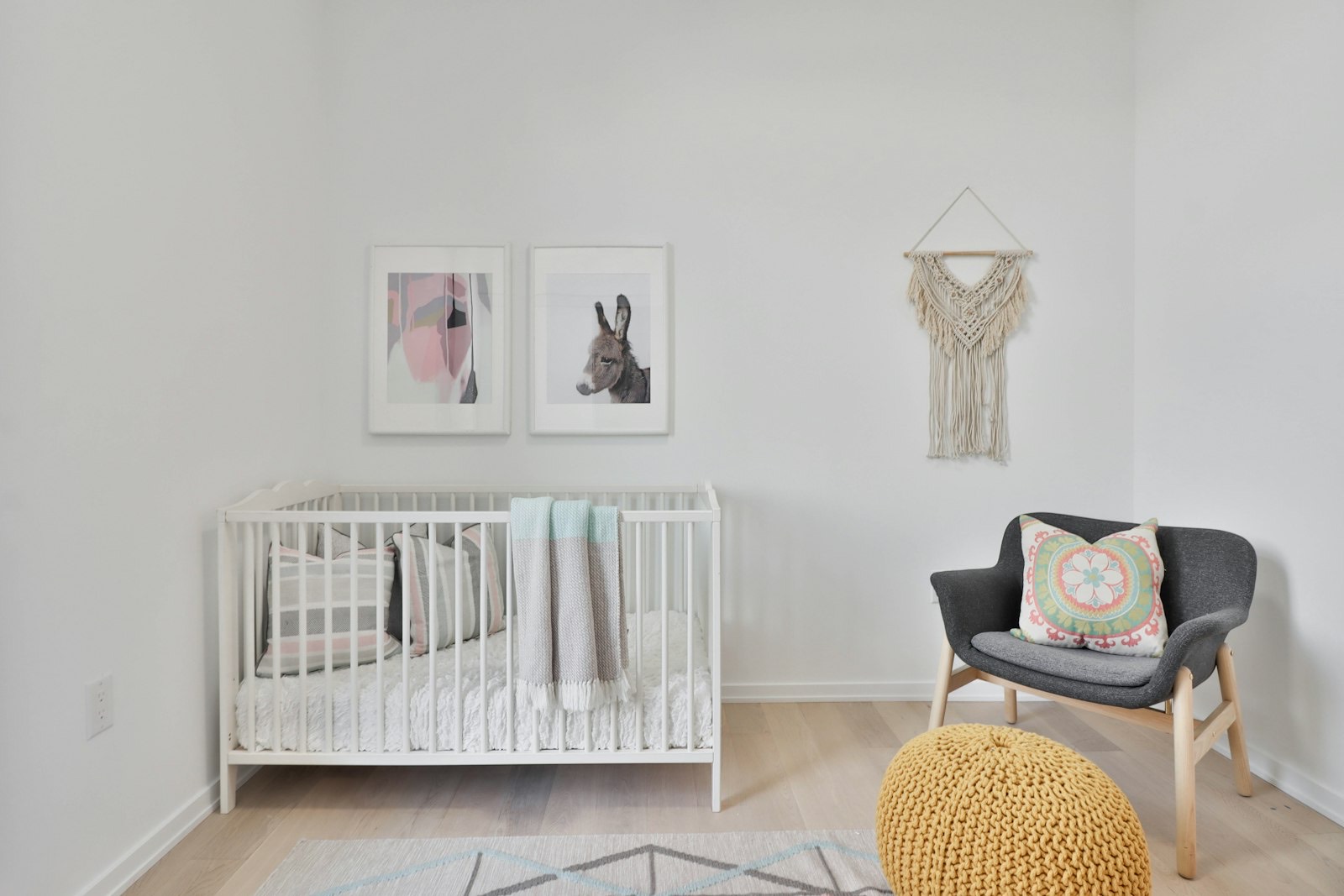 Rocking chair positioned in a nursery beside a window