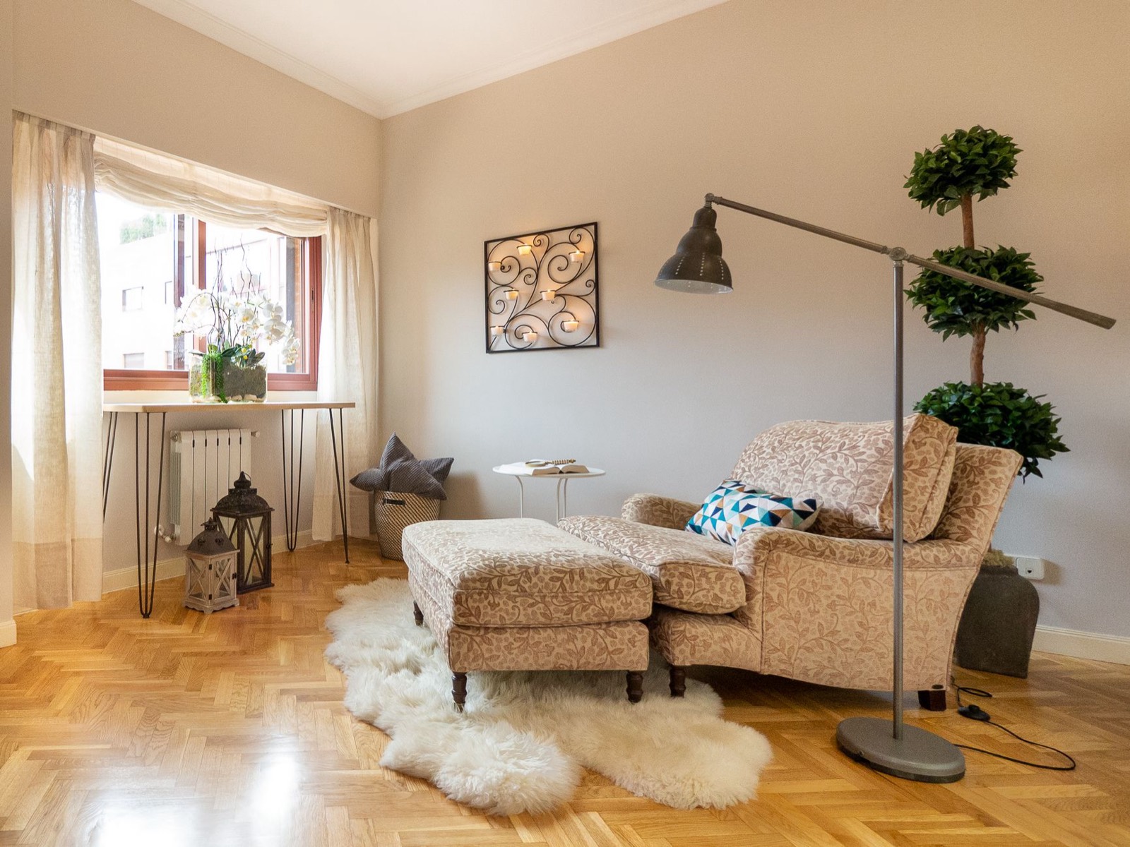 Floor lamp lighting the corner of a seating group, the darkest point in an L-shaped layout