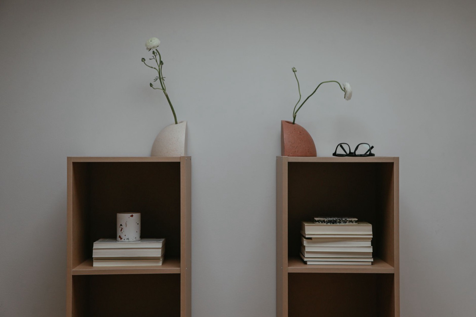 Vase, books and decorative objects grouped at varying heights on a cabinet top