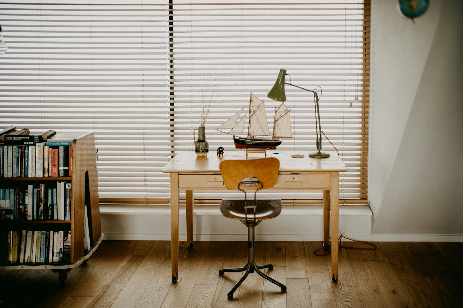 Floor lamp positioned beside a chair to provide directed reading light