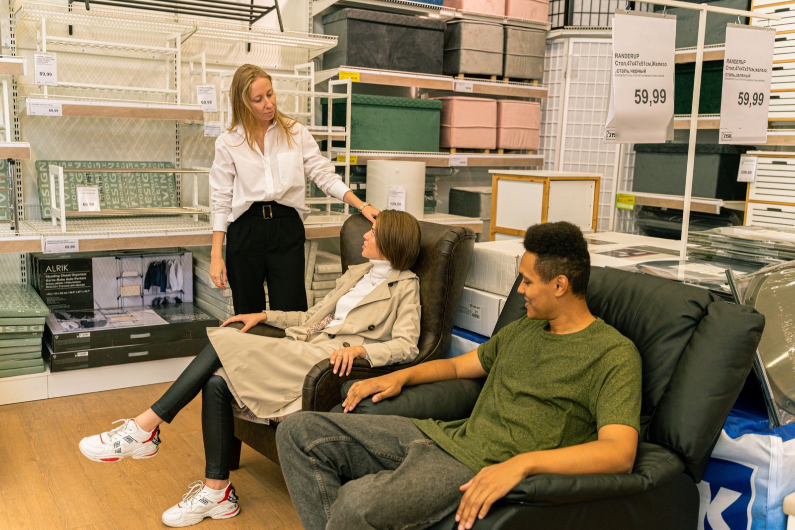 Shoppers testing a sofa in a showroom, the one thing online cannot offer