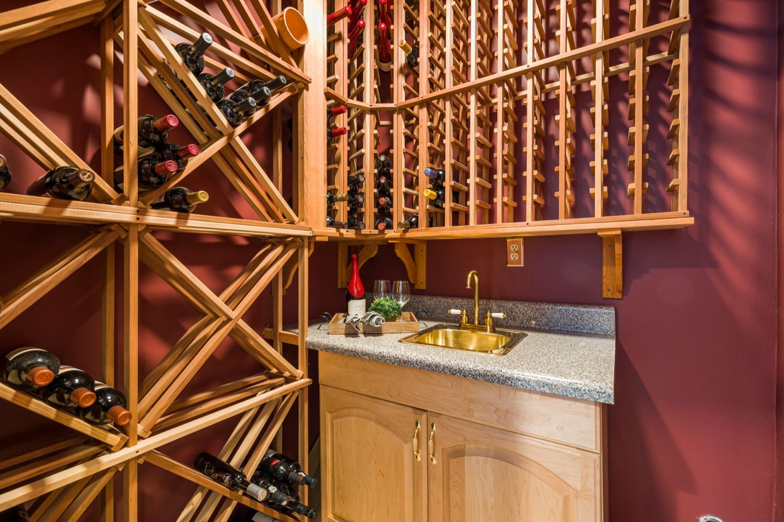 Wine bottles stored horizontally in a wooden rack to keep corks sealed
